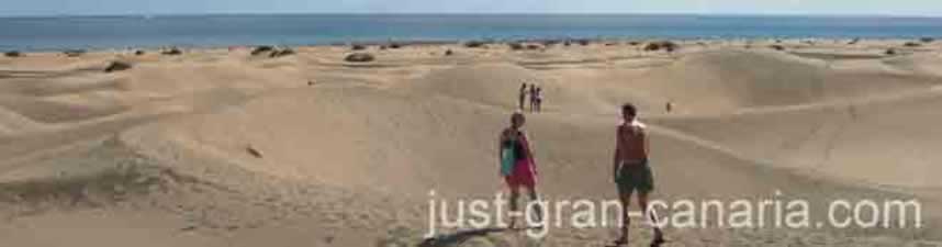 People walking across the dunes